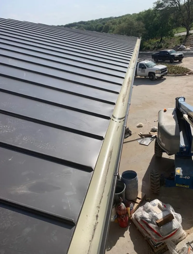 Standing seam panel and gutter detail on a metal roofing jobsite in El Rio
